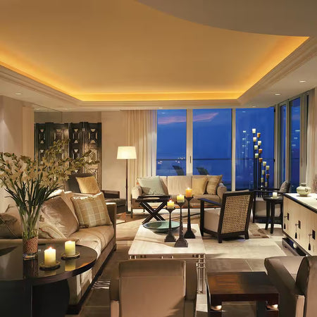 Armacost RibbonFlex Pro 24V White Dim-To-Warm LED Strip Light installed in a living room cove ceiling, providing warm ambient accent lighting.